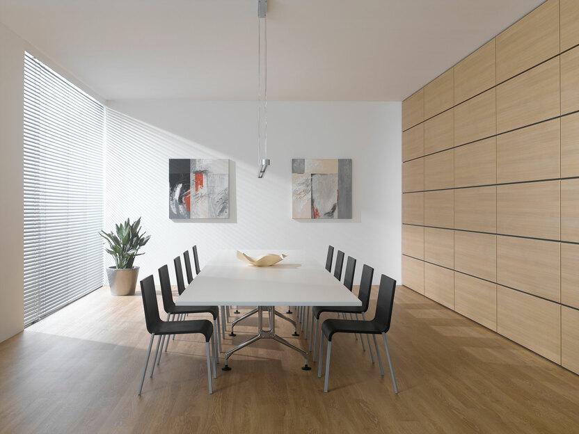 Impression eines Konferenzraumes im Hotel mit Einbauschrank aus Massivholz und weißem Konferenztisch